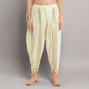 May include: A set of three ceramic mugs with a speckled, matte finish. The mugs are in shades of cream, light gray, and dark gray. Each mug has a simple, minimalist design, perfect for coffee or tea.