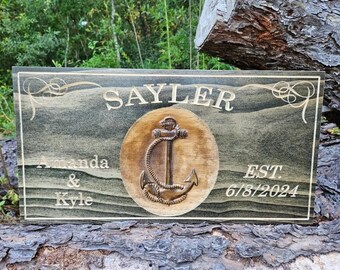 May include: A wooden sign with a carved anchor and the text "Sayler Amanda & Kyle Est. 6/8/2024".