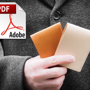 May include: Two leather wallets, one brown and one beige, held in a person's hand.