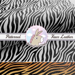 May include: Black and white zebra patterned faux leather fabric. The fabric is textured and has a slight sheen. The fabric is folded in half and the edges are visible. The fabric is labeled "Patterned Faux Leather".