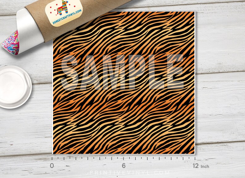 May include: A 12-inch square sheet of orange and black tiger stripe vinyl. The vinyl is a repeating pattern of orange and black stripes.