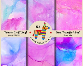 May include: Six different abstract designs in shades of pink, blue, and purple. The designs are labelled with numbers 1 through 6. The designs are for printed craft vinyl and heat transfer vinyl. The text "Printed Craft Vinyl" is written in black with the text "Oracal 631/651" below it. The text "Heat Transfer Vinyl" is written in black with the text "Siser HTV" below it. A donkey with a rainbow striped pattern is in the centre of the image with the text "893" above it and the text "DONKEY CRAFT VINYL" below it.