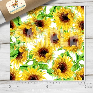 May include: A square print featuring a watercolor pattern of sunflowers with yellow petals and brown centers, interspersed with green leaves, against a white background. The word "SAMPLE" is overlaid on the design. The print measures approximately 12 inches.