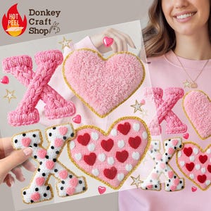 May include: A clear sheet featuring pink heart and "XOX" iron-on patches. The patches include knitted letters, fluffy hearts, and hearts with polka dots. Gold stars and hearts are also included. The Donkey Craft Shop logo is visible.