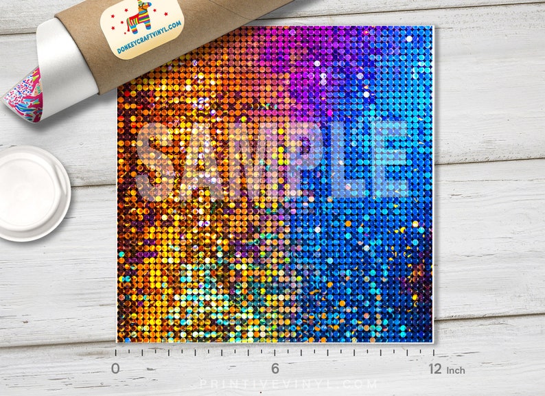 May include: A square sheet of vinyl with a gradient of colors, transitioning from orange to purple to blue. The surface is covered in small, reflective circles. The word "SAMPLE" is printed across the center. The sheet measures approximately 12 inches.