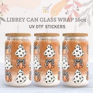 May include: Three 16oz glass can wraps with a Halloween theme. The wraps feature a white ghost with black eyes and a black bow, and a pumpkin with a black and white checkered bow. The wraps are designed for use with UV DTF stickers.