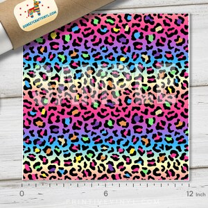 May include: Rainbow leopard print fabric with black spots on a gradient background of pink, orange, yellow, green, blue, and purple. The fabric is 12 inches wide.