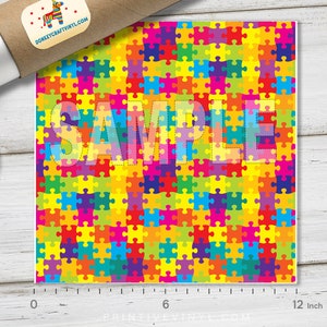 May include: A sample of colorful puzzle piece patterned vinyl, measuring 12 inches wide. The word "SAMPLE" is printed over the vinyl.