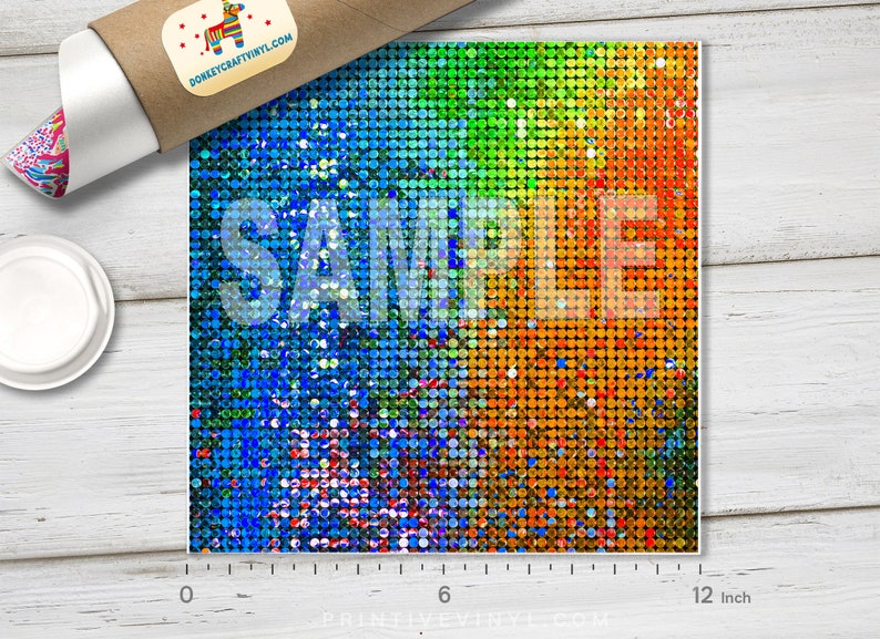 May include: A square sheet of colorful, iridescent vinyl with a mosaic pattern. The colors transition from blue to green to orange. The word "SAMPLE" is printed across the center. The sheet measures 12 inches across.
