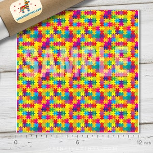 May include: A colorful puzzle piece pattern with a repeating design of red, orange, yellow, green, blue, purple, and pink puzzle pieces. The pattern is 12 inches wide.