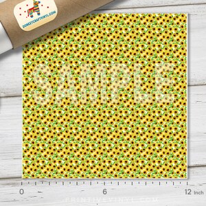 May include: A sheet of vinyl featuring a repeating pattern of yellow sunflowers with brown centers and green leaves. The word "SAMPLE" is printed across the design. The sheet is approximately 12 inches wide.