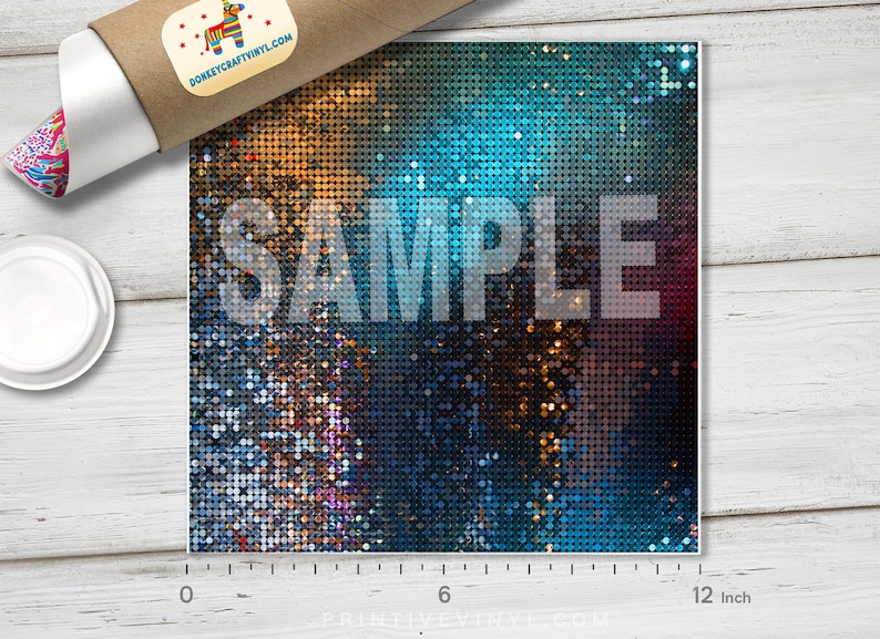 May include: A square sheet of vinyl with a shimmering, sequined design in shades of gold, blue, and purple. The word "SAMPLE" is printed across the center in a semi-transparent white font. The sheet measures 12 inches across.