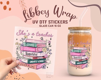 May include: A glass can with a wooden lid and a straw, displaying a vibrant design with the words "She's a teacher" and a stack of books. The design includes the words "Strong", "Victorious", "Beautiful", "Capable", "Greatly Loved", and "Never Alone".