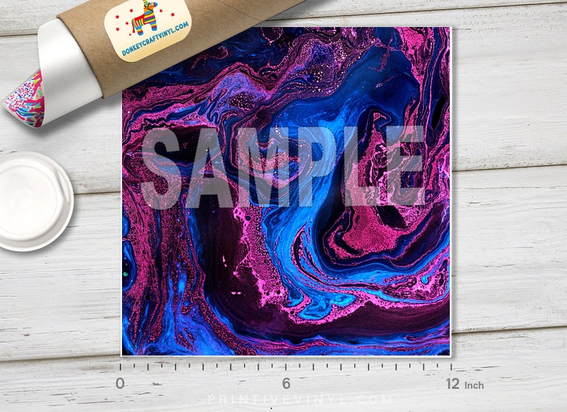 May include: A square print with a swirling abstract design in shades of blue, purple, and pink. The word "SAMPLE" is overlaid on the design. The print is approximately 12 inches wide. A rolled-up poster and a lid are in the background.