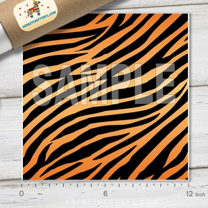 May include: A 12-inch square sheet of orange and black tiger stripe vinyl. The sheet is marked "SAMPLE" in white.