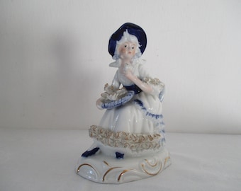 Porcelain figurine baroque, putte, girl, hat, flowers, lace, golg, blue, white