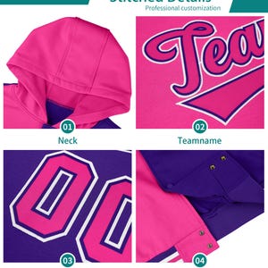 May include: A pink and purple hoodie with stitched details. The hoodie has a hood, a zipper, and a pocket. The text "Team" is stitched on the front of the hoodie. The number "00" is stitched on the back of the hoodie. The hoodie has a pink and white stripe on the bottom.