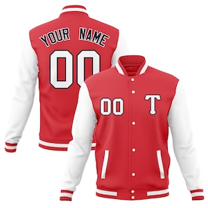 May include: Red and white varsity jacket with a white number "00" and the text "YOUR NAME" on the back. The front of the jacket has a white number "00" and a navy blue letter "T" on the left chest.