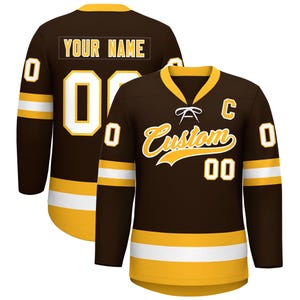 May include: A brown hockey jersey with gold and white accents. The jersey features the word "Custom" in gold script, the number "00", and the letter "C". The back of the jersey has the text "YOUR NAME" and the number "0".