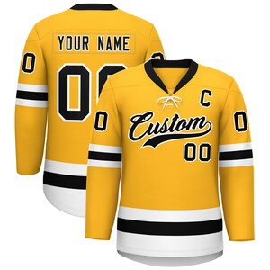 May include: A yellow hockey jersey with black and white accents. The jersey features the text "YOUR NAME" on the back and "Custom" on the front, along with the number "00". The jersey has a black collar and white cuffs.