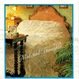 May include: A vintage crochet pattern cover featuring a detailed, cream-colored bedspread with floral and geometric patterns. The text "Material Thoughts" is visible. The bedspread is draped over a bed with a wooden headboard.