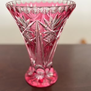 May include: A set of three ceramic vases in varying heights and shapes. The vases are glazed in a matte white finish, offering a minimalist aesthetic. The tallest vase is approximately 10 inches high.