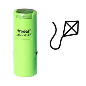 May include: Green self-inking stamp with the text "trodat printy 4612" and a black line drawing of a kite.