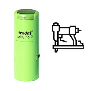 May include: Green self-inking stamp with the text "trodat printy 4612" and a black outline of a staple gun.
