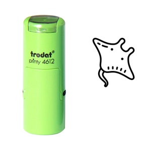 May include: Green self-inking stamp with the text "trodat printy 4612" and a black line drawing of a manta ray.