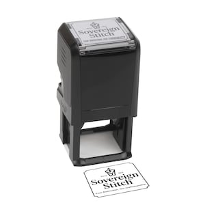 May include: A black self-inking rubber stamp with a rectangular base. The top label displays the text Sovereign Stitch, Since 1912, and Your Distinction, Our Craftsmanship. A matching black ink impression of the same text is visible below the stamp.