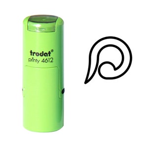 May include: A green self-inking stamp with the text "trodat printy 4612" and a black outline of a curved shape.