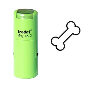 May include: A green self-inking stamp with the text "trodat printy 4612" and a black outline of a bone.
