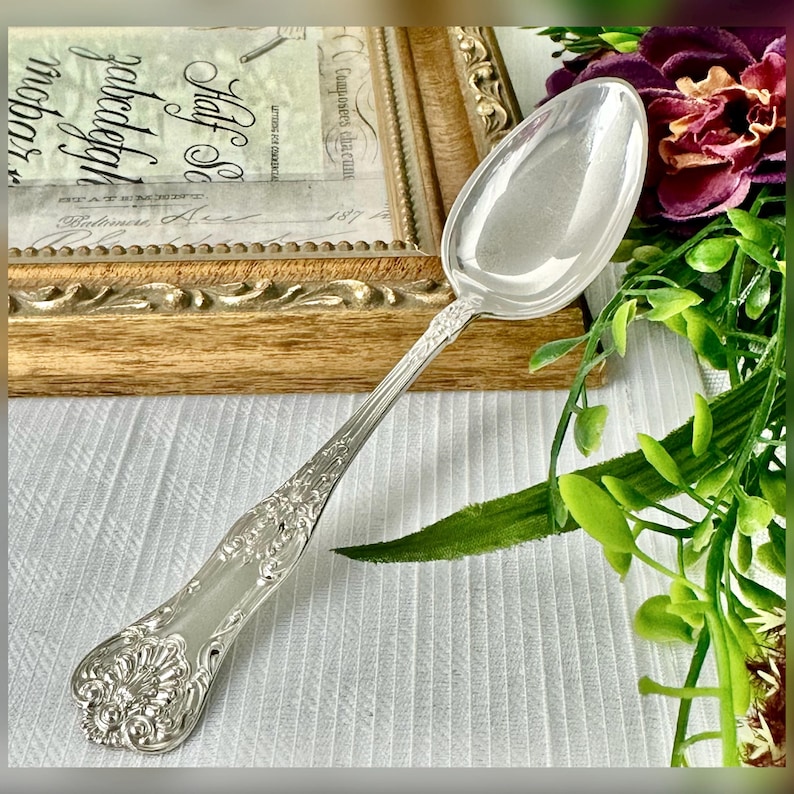 Dominick Haff New King Sterling Silver Teaspoon " Flatware. Silver-colored utensil with a decorative handle.