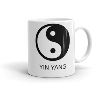 May include: White ceramic mug with a black yin yang symbol and the text "YIN YANG" printed on the front.