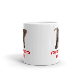 A white ceramic mug with a printed image of a dog on it, along with the text "YOUR PHOTO HERE" printed on it.