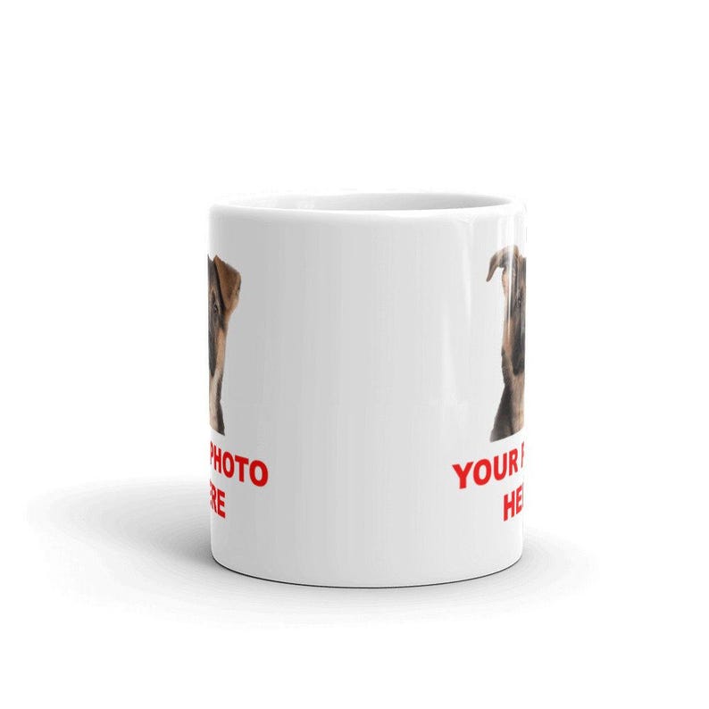 A white ceramic mug with a printed image of a dog on it, along with the text "YOUR PHOTO HERE" printed on it.