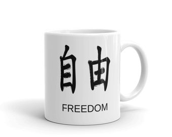 May include: White ceramic mug with black Chinese characters for "freedom" and the word "freedom" printed below.