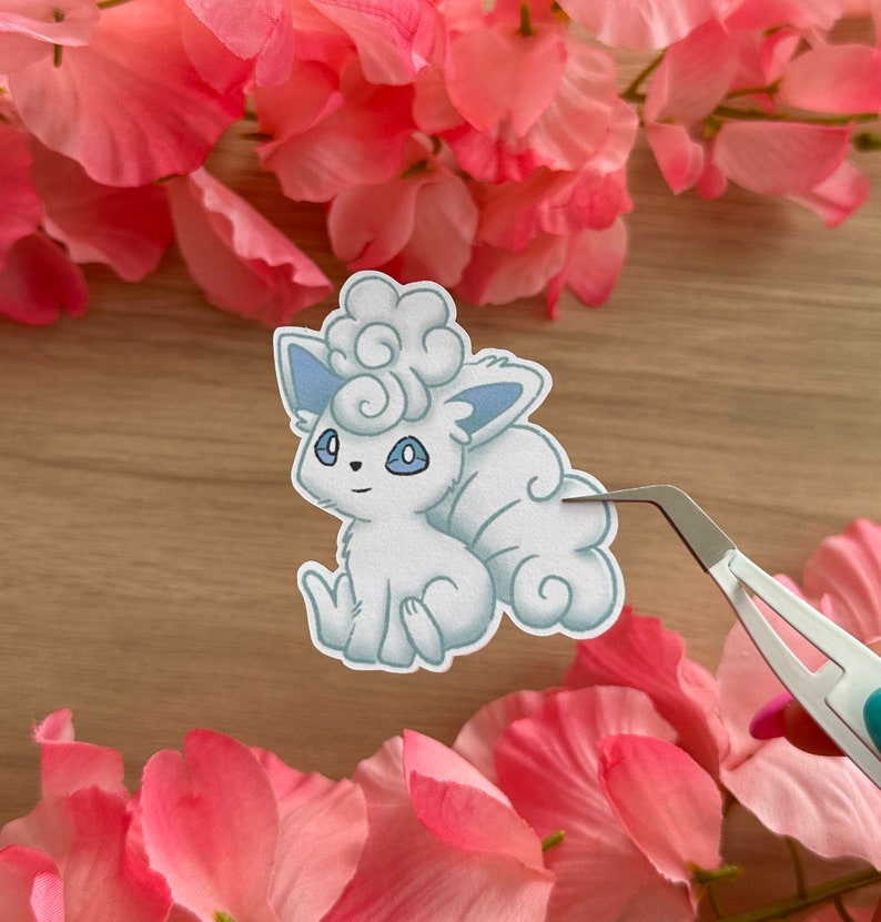 May include: A white and blue cartoon sticker of a fluffy, cloud-like Pokemon character with a curled tail.