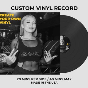 May include: A custom vinyl record featuring a black and white square cover with the text CUSTOM VINYL RECORD, CREATE YOUR OWN VINYL, and 20 MINS PER SIDE / 40 MINS MAX MADE IN THE USA. The cover shows a person in a crop top, and the record has an A label.