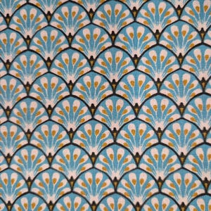 May include: Close-up of a fabric with a repeating pattern of stylized peacock feathers. The design features teal, white, and gold elements outlined in black, creating a textured, layered effect. The fabric has a light, airy appearance.