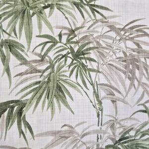 May include: A fabric with a bamboo leaf pattern. The design features green and gray bamboo leaves and stalks against a white background. The leaves have a detailed, naturalistic appearance, creating a textured effect.