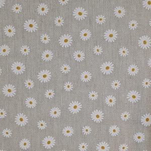 May include: A grey fabric with a white daisy pattern. The daisies have yellow centres.