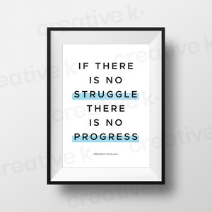 May include: A framed print featuring the quote "IF THERE IS NO STRUGGLE THERE IS NO PROGRESS" by Frederick Douglass. The text is black on a white background, with light blue highlighting. The frame is black.