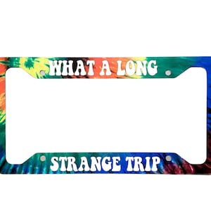 May include: Tie-dye license plate frame with the text "What a long strange trip" in white.