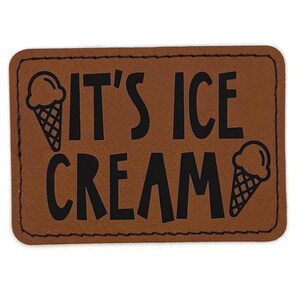 May include: A brown rectangular patch with rounded corners. The patch features the words "IT'S ICE CREAM" in bold black letters, with a black ice cream cone graphic on each side of the text.