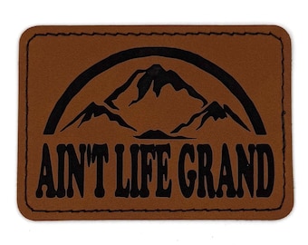 3.5” x 2.5” Ain’t Life Grand Patch | Laser Engraved | Rawhide/Black | Iron or stitch | Panic Fan Art