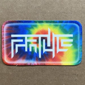 May include: A tie-dye fabric patch with the word "FANTASY" in white lettering.