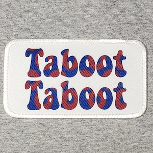 May include: White patch with a red and blue "Taboot" logo repeated twice.