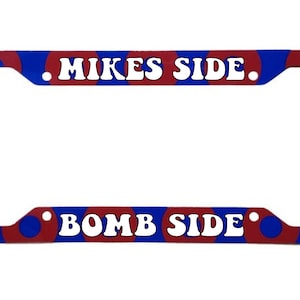 May include: A red and blue license plate frame with the text "MIKES SIDE" and "BOMB SIDE" in white.