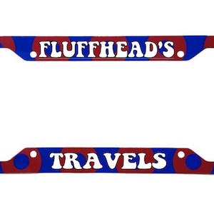 May include: A blue and red license plate frame with the text "FLUFFHEAD'S TRAVELS" in white.